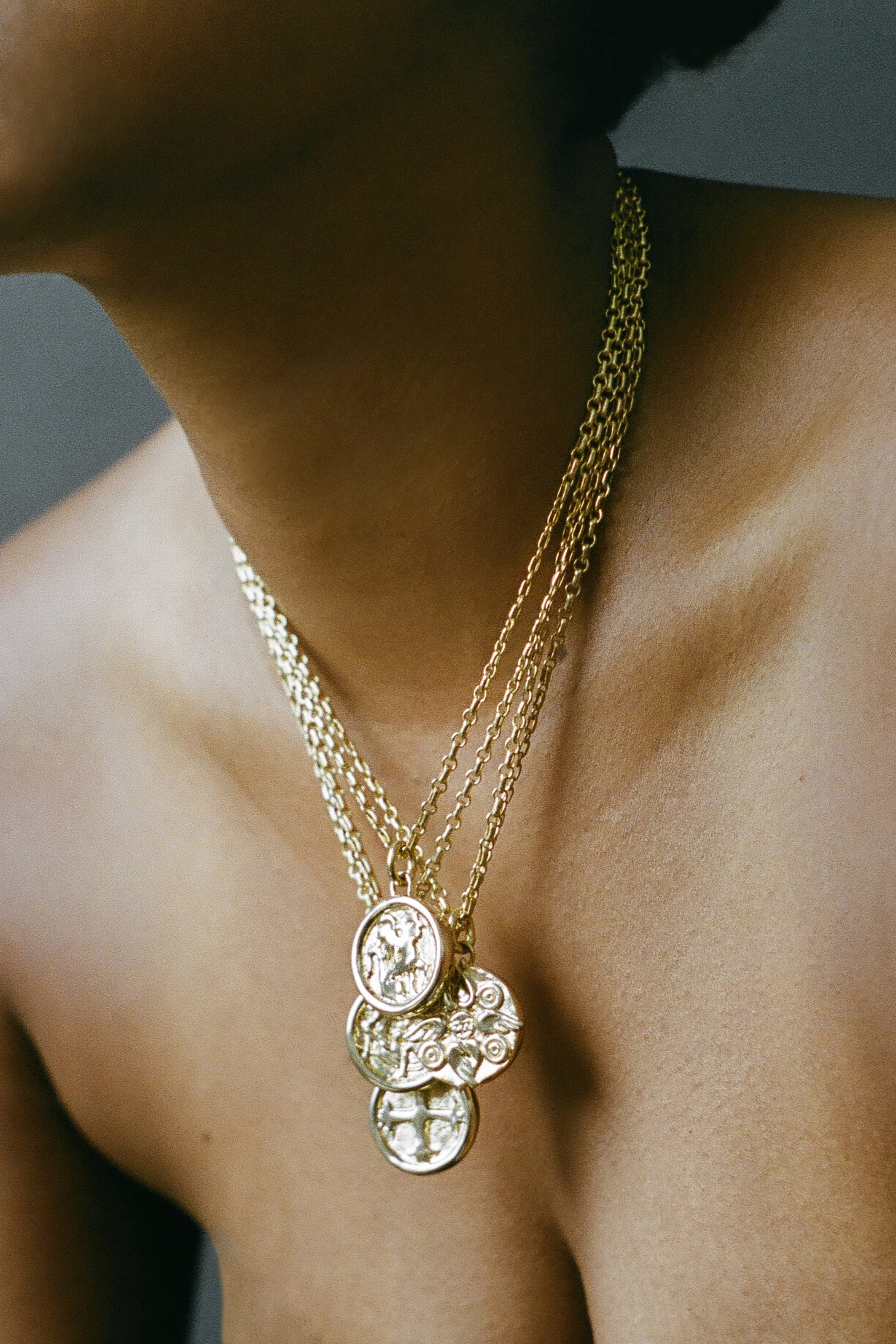 Model wearing gold AMS x LL Seduced By An Angel Pendant