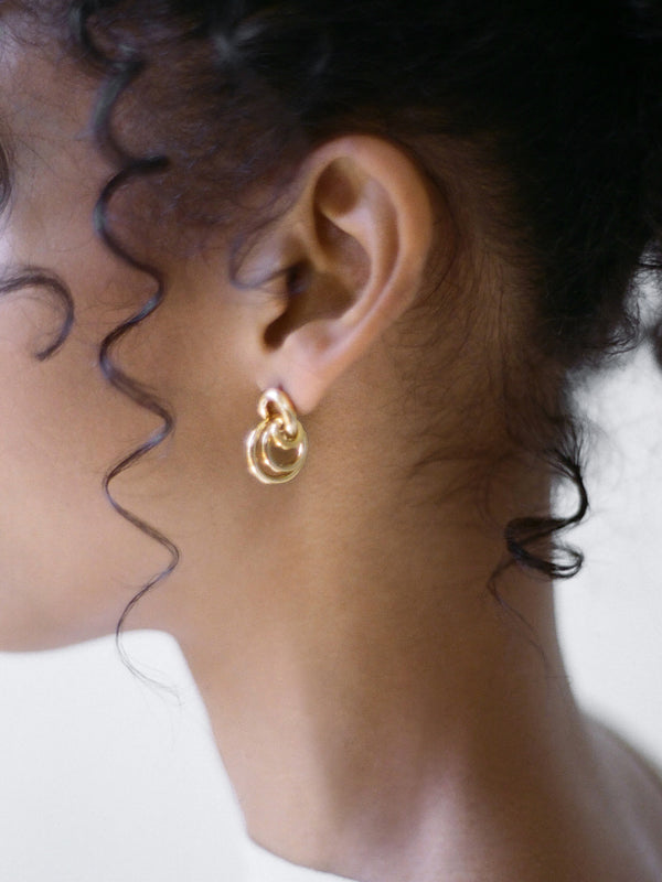 Model wearing Laura Lombardi gold Aria Earrings