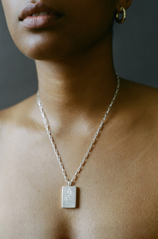 Model wearing AMS x LL Silver Dancer Pendant