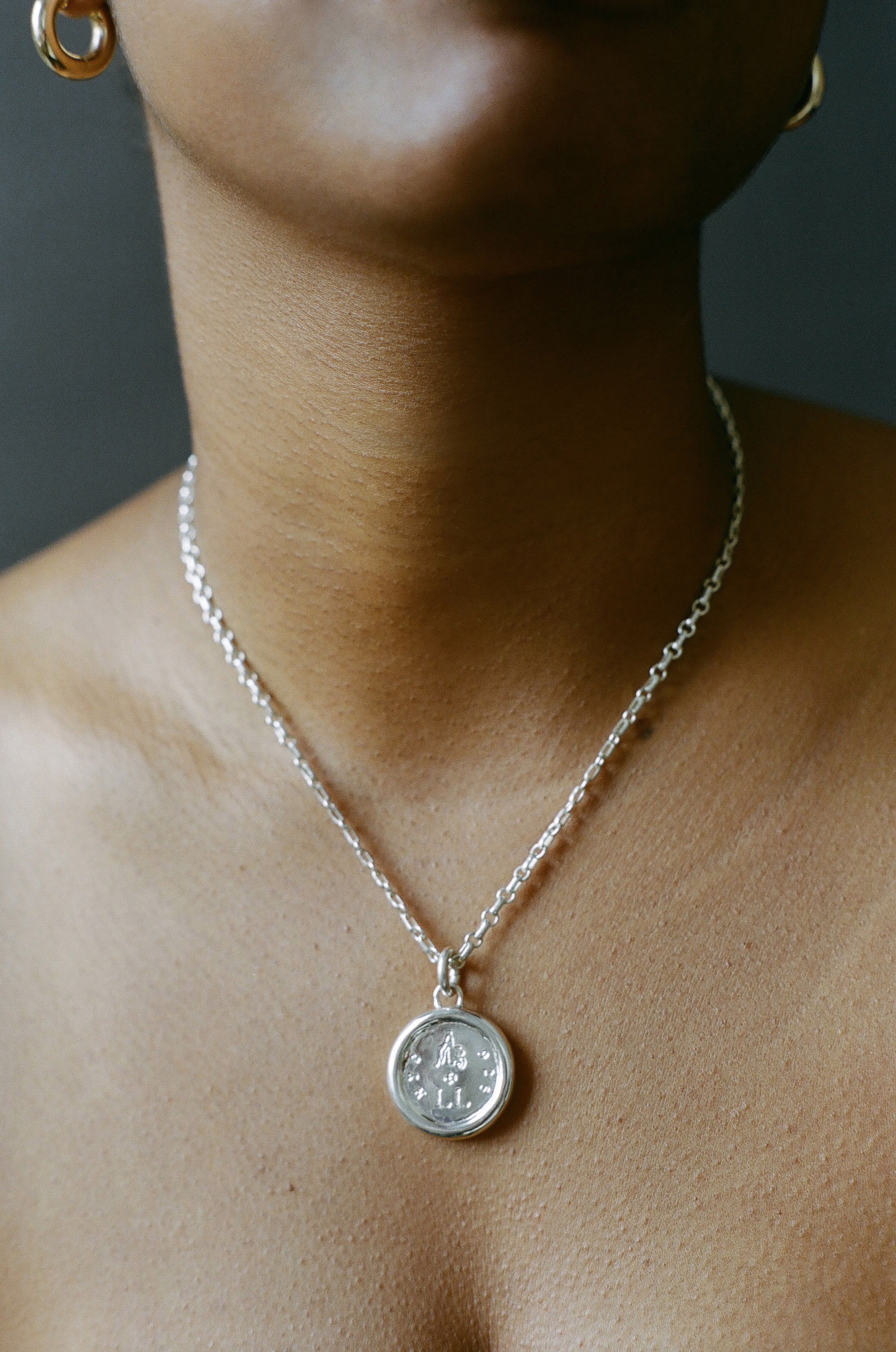 Model wearing AMS x LL Silver Guide Pendant