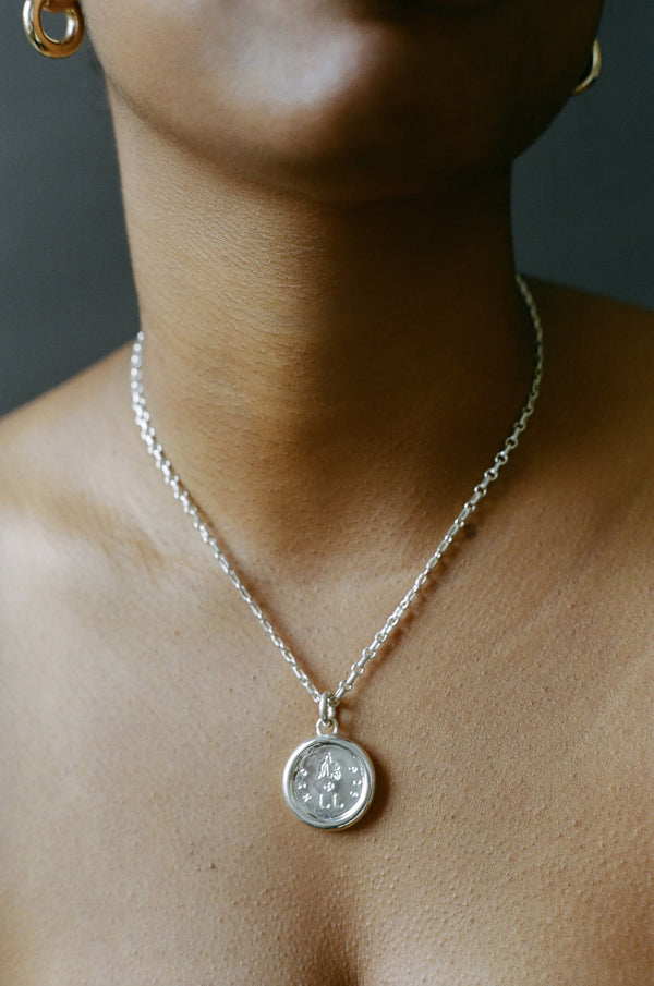 Model wearing AMS x LL Silver Guide Pendant