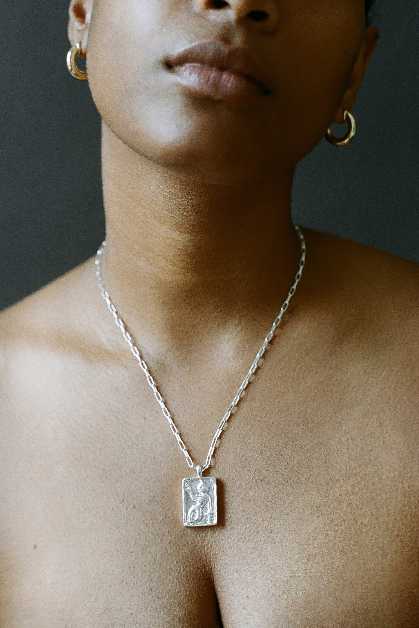 Model wearing AMS x LL Silver Dancer Pendant