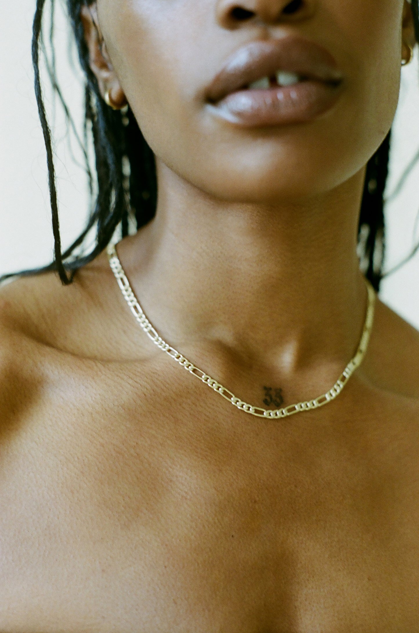 Model wearing Laura Lombardi gold Figaro Chain