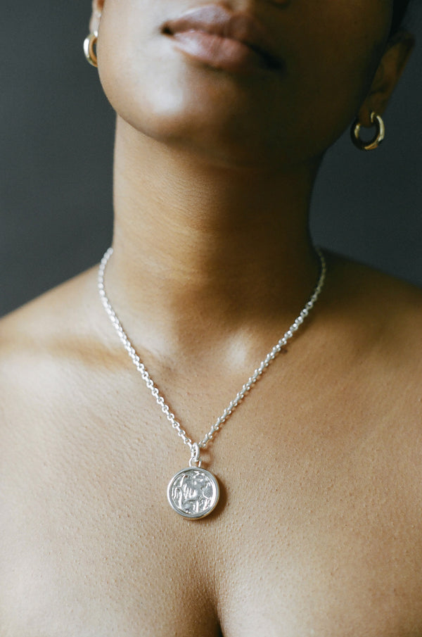 Model wearing AMS x LL Silver Guide Pendant