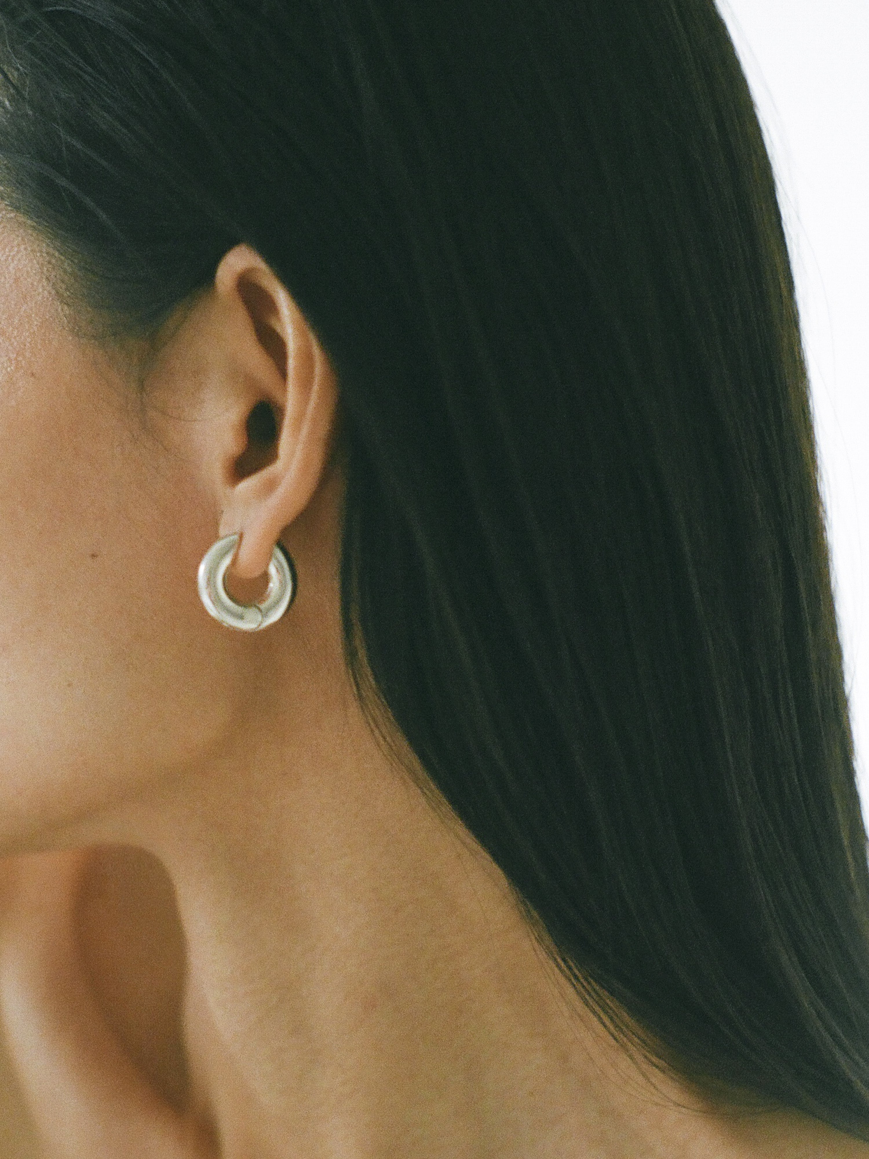 Model wearing Laura Lombardi Silver Medium Terra Hoops