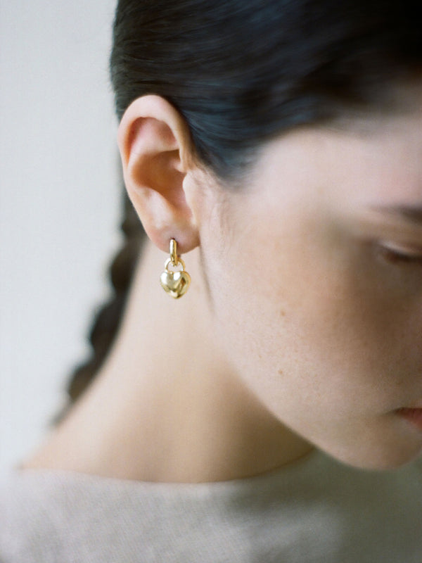 Model wearing Laura Lombardi gold Mini Amorina Earrings