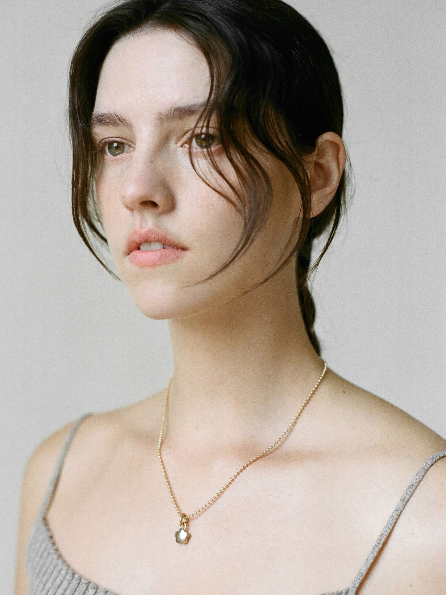 Model wearing Laura Lombardi gold Mini Fiorella Pendant