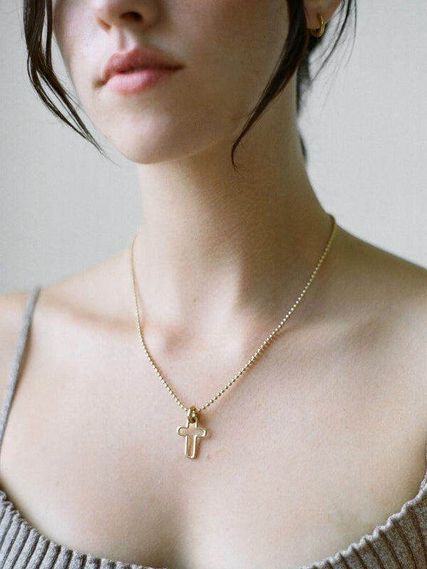 Model wearing Laura Lombardi gold Mini Madda Pendant