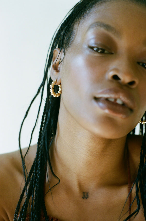 Model wearing gold Maremma Earrings