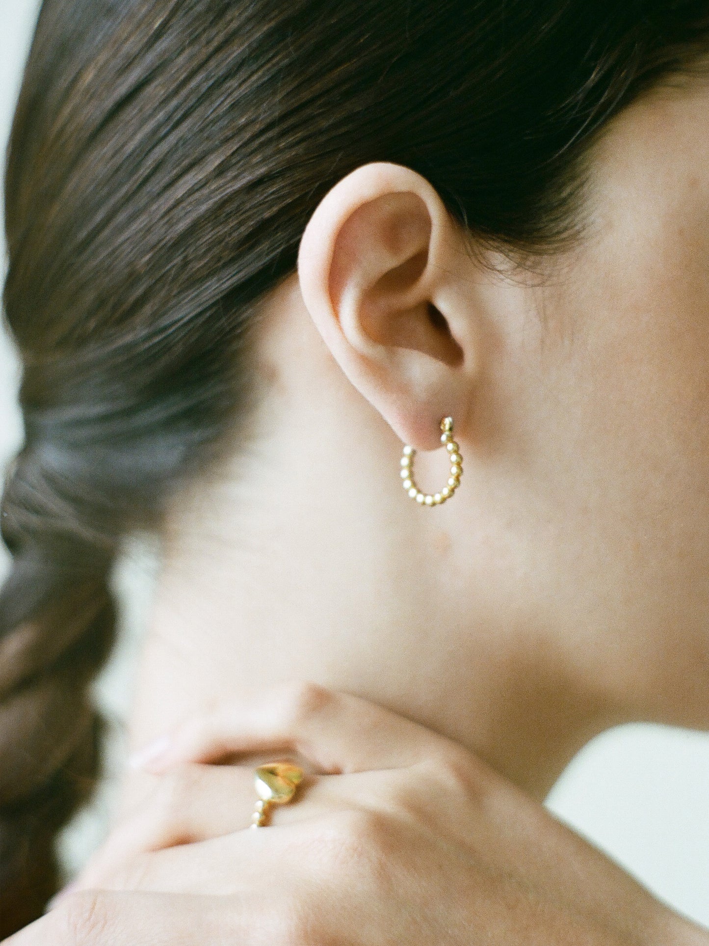 Model wearing Laura Lombardi gold Pallina Earrings