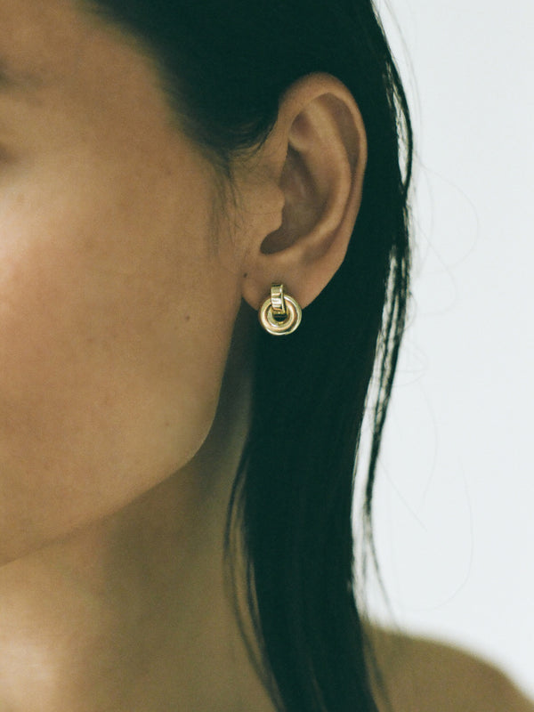 Model wearing Laura Lombardi gold Piega Earrings