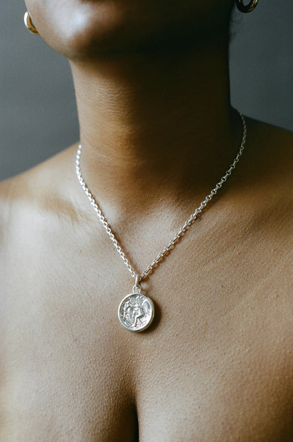 Model wearing AMS x LL Silver Seduced By An Angel Pendant