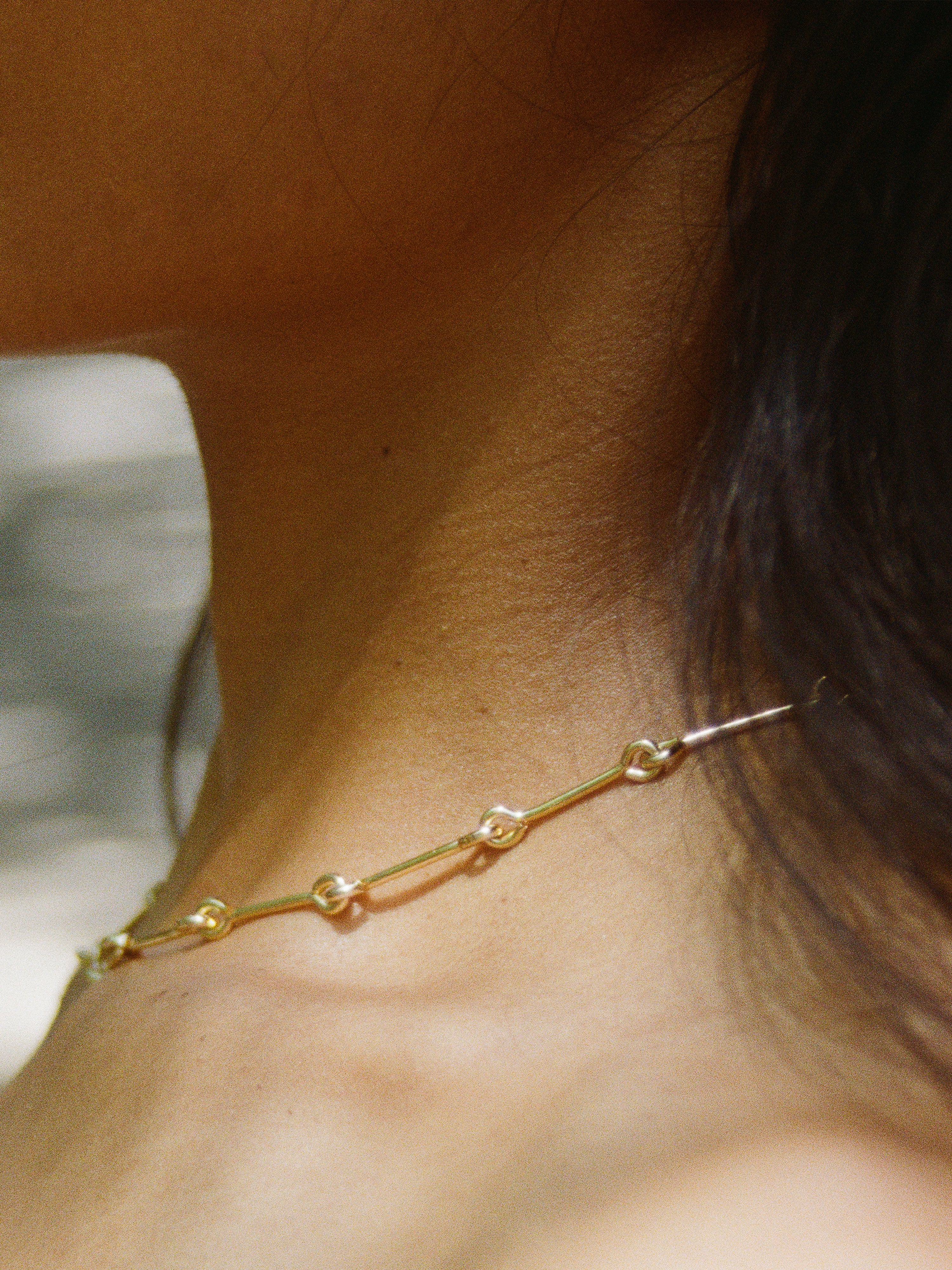 Model wearing Laura Lombardi gold Treccia Necklace