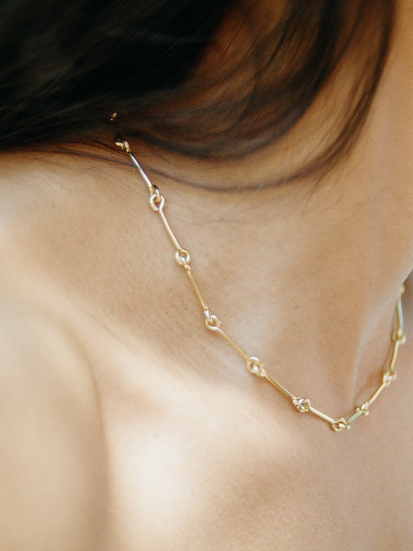 Model wearing Laura Lombardi gold Treccia Necklace