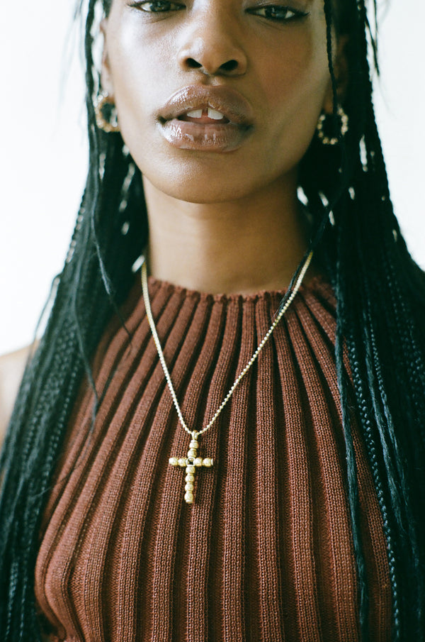 Model wearing Laura Lombardi gold Torre Pendant