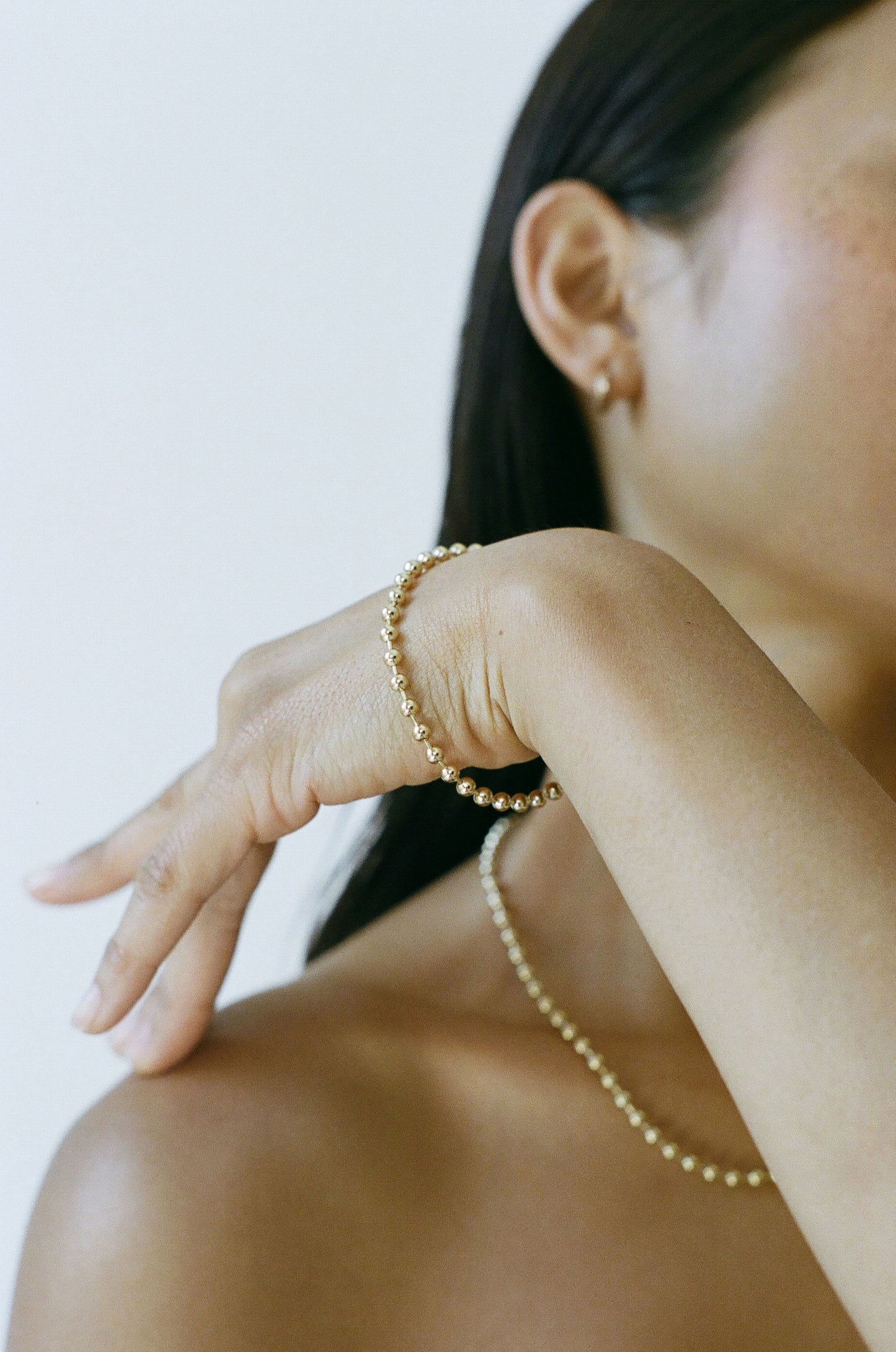 Model wearing Laura Lombardi gold Ball Chain Bracelet and Necklace