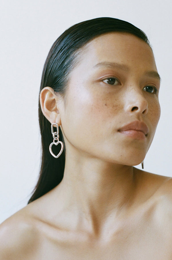 Model wearing Laura Lombardi Silver Beatta heart earrings.