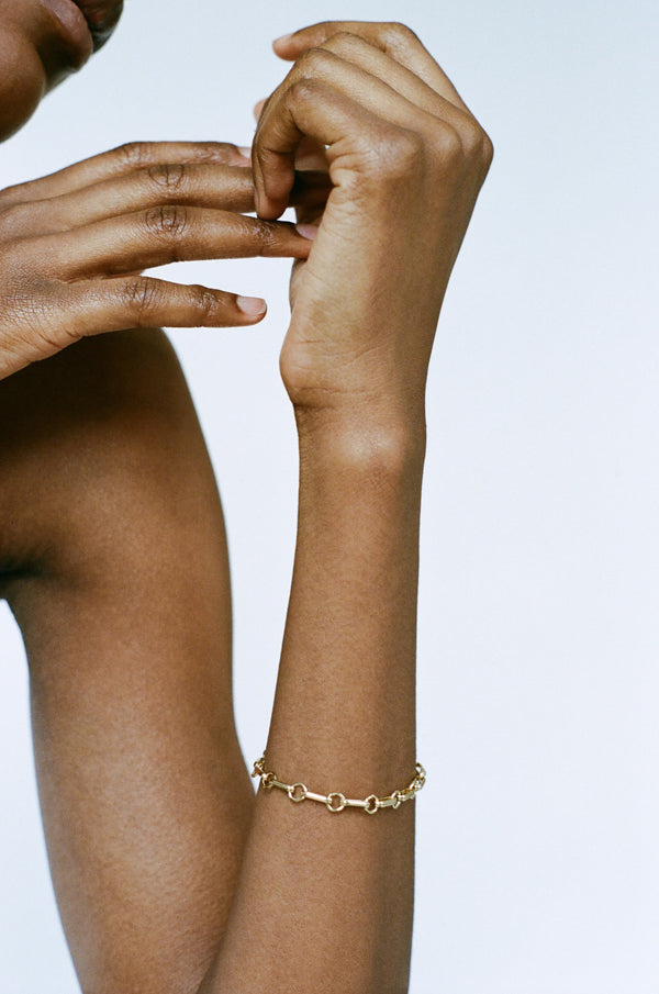 Model wearing Laura Lombardi gold Bar Chain Bracelet.