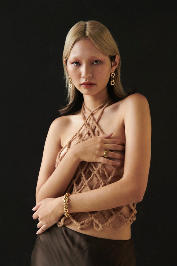 Model wearing Laura Lombardi gold Cinzia Bracelet and Cinzia Earrings