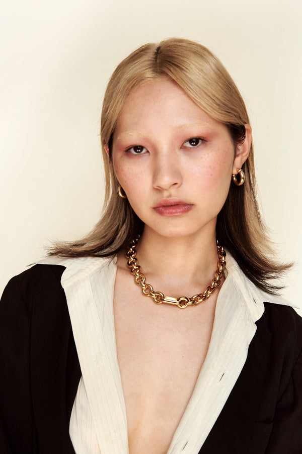 Model wearing Laura Lombardi gold Cinzia Necklace and Mini Icona Earrings.