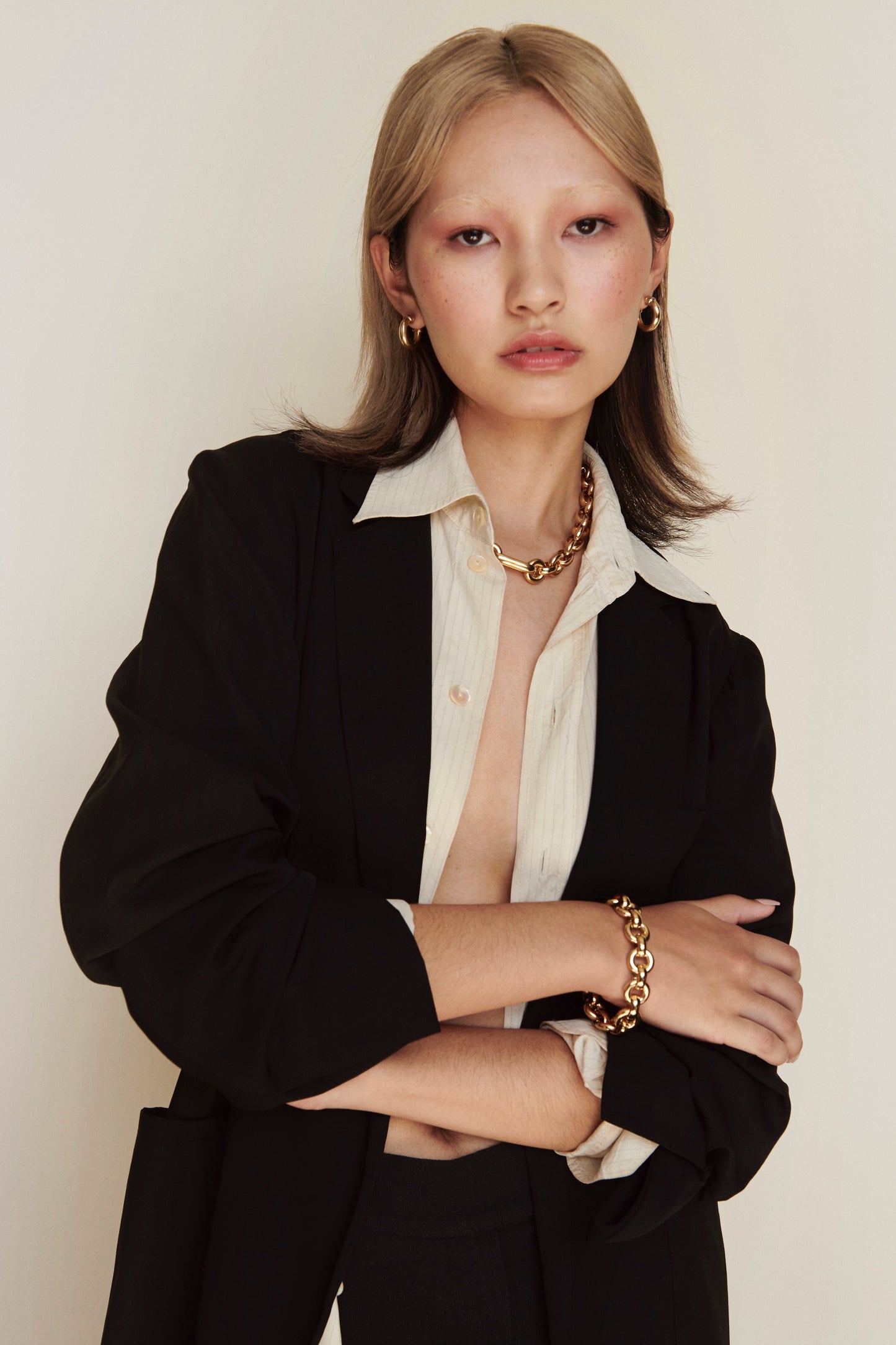 Model wearing Laura Lombardi gold Cinzia Necklace, Cinzia Bracelet and Mini Icona Earrings.