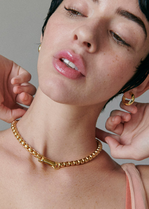 Model wearing Laura Lombardi gold Lella Necklace with Mini Cusp Hoops.