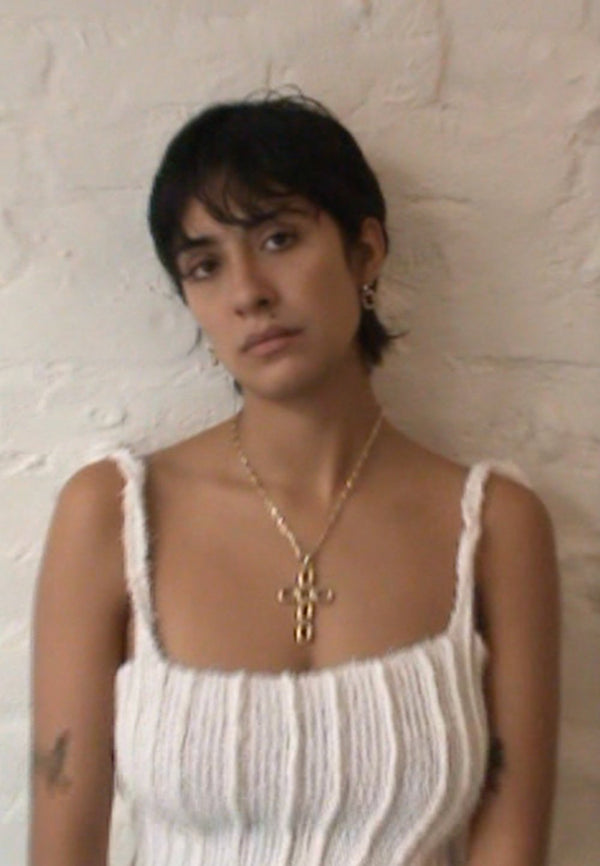 Model wearing Laura Lombardi gold Luciana Pendant and Greca Earrings.