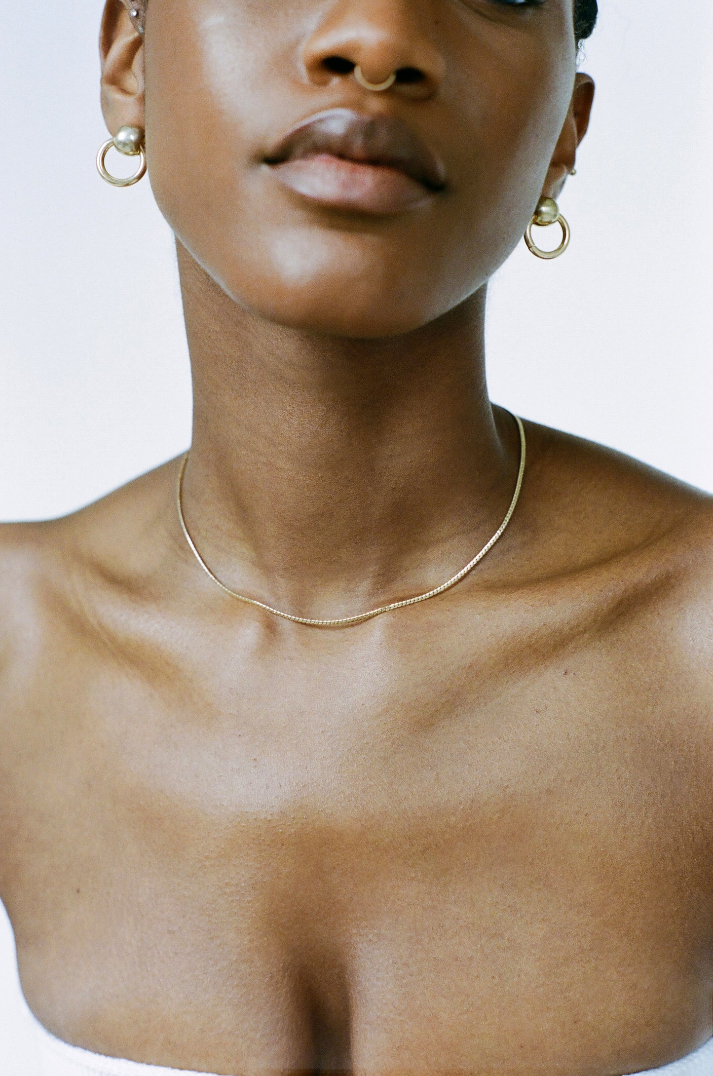 Model wearing Laura Lombardi gold Mini Omega Chain with Rina Earrings.