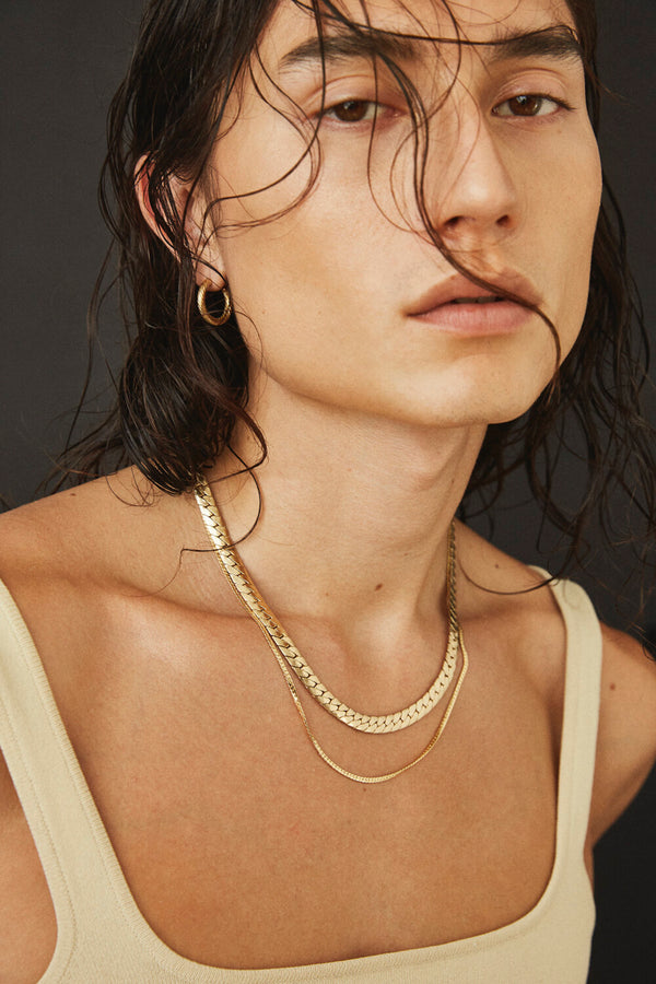 Model wearing Laura Lombardi gold Piatta Necklace with Mini Omega Chain.