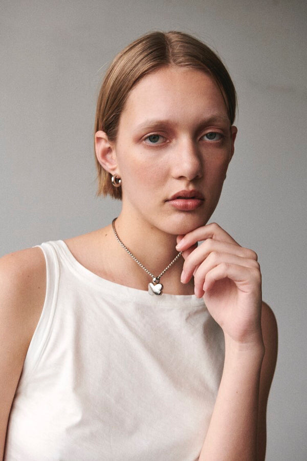 Model wearing Silver Mini Hoop earrings with Silver Noemi Pendant.