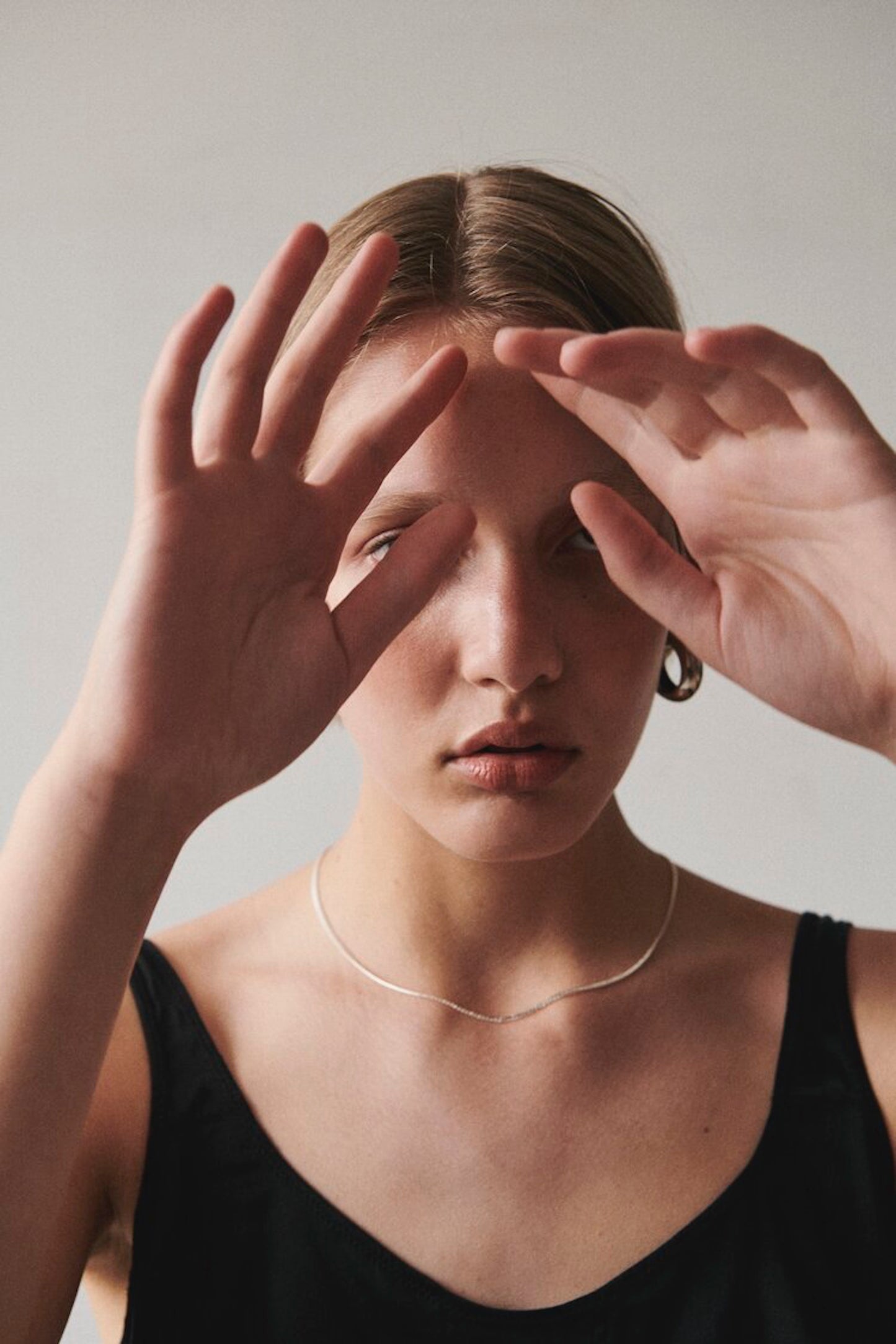 Model wearing Laura Lombardi Silver Mini Omega Chain and Silver Cusp Hoops.