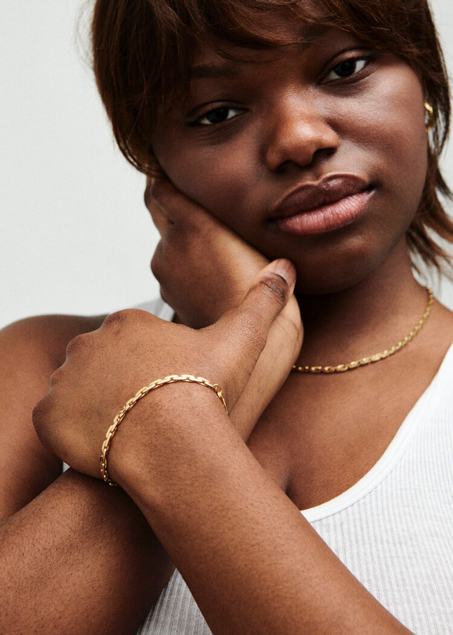 Model wearing gold Strada Bracelet and Strada Necklace.